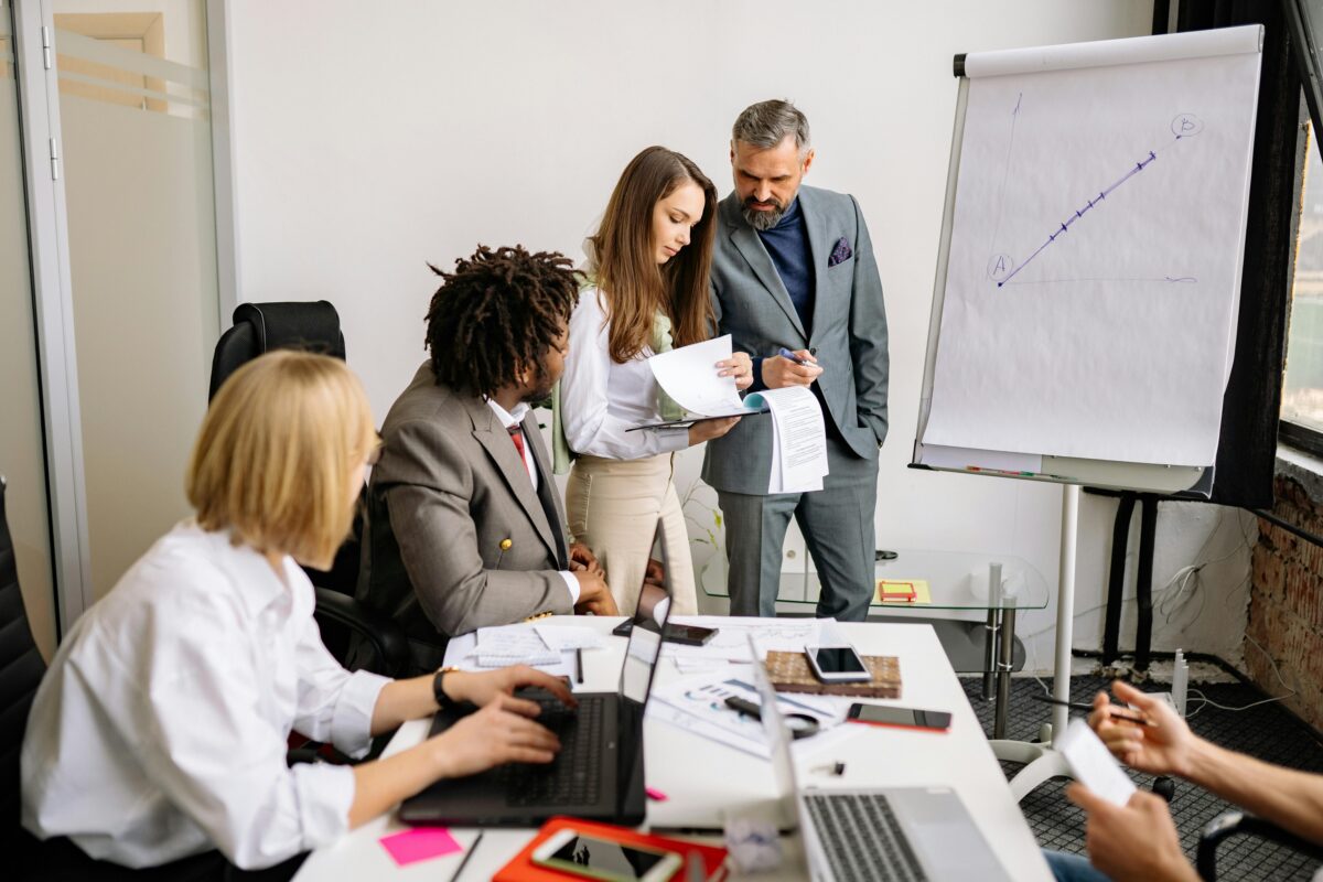 Marketing strategy team reviewing documents during a business planning meeting